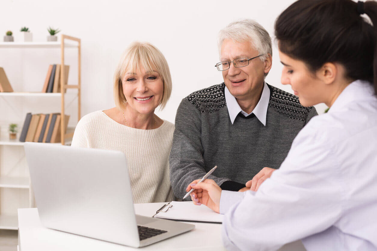 Elderly couple designing a care plan with their doctor